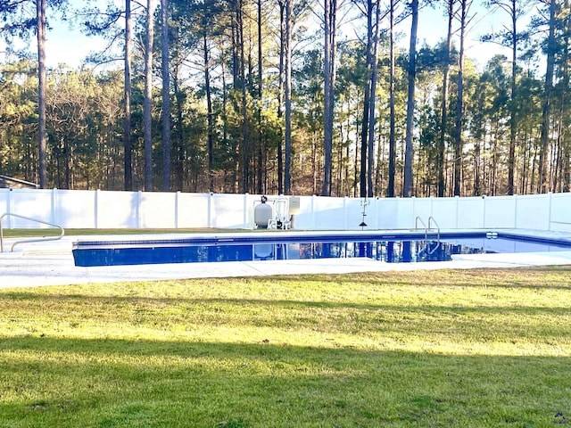 view of swimming pool featuring a fenced in pool, a fenced backyard, and a lawn