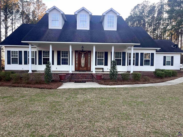 view of front of home with covered porch and a front lawn