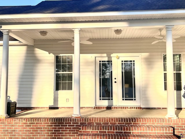 property entrance with a ceiling fan and roof with shingles