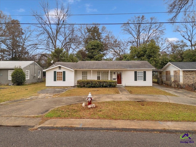 view of front of house with a front lawn and aphalt driveway