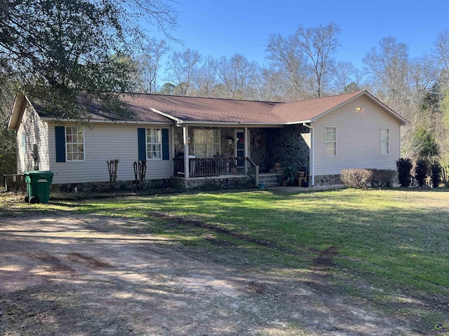 ranch-style house with a porch and a front lawn