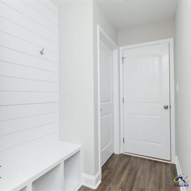 mudroom with dark wood-type flooring and baseboards