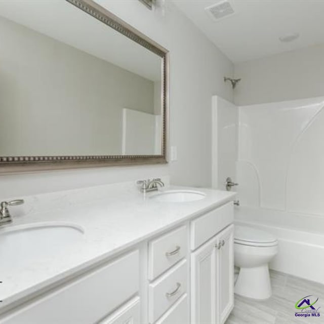 full bathroom featuring toilet, shower / bath combination, double vanity, and a sink