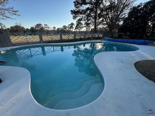 view of swimming pool with fence and a fenced in pool