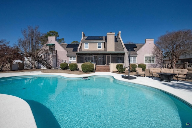 outdoor pool featuring a patio area and an outdoor hangout area