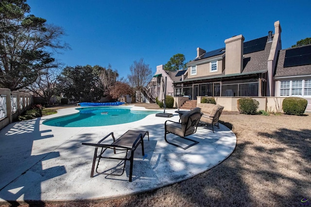 pool with stairway, a patio area, fence, and a sunroom