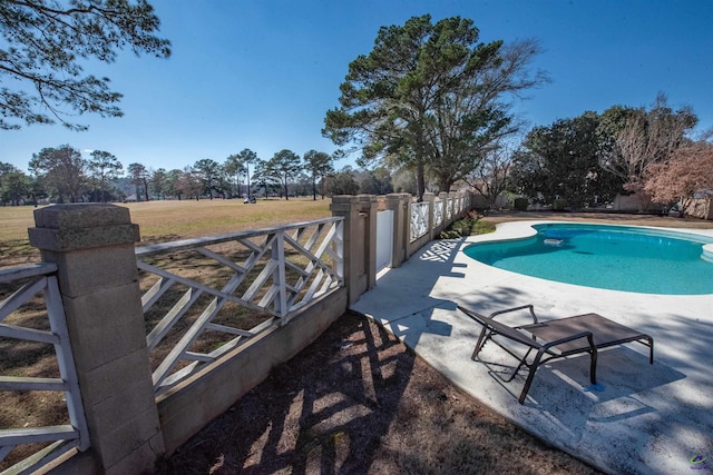 view of swimming pool featuring a patio area, fence, and a fenced in pool