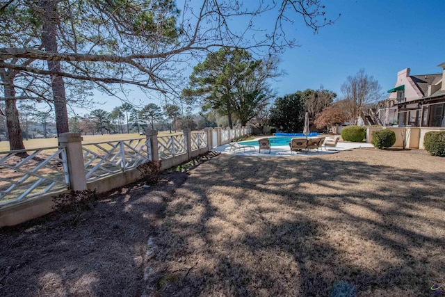 view of yard featuring fence private yard, a patio area, and a fenced in pool