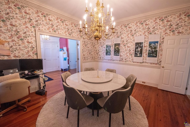 dining room with wallpapered walls, ornamental molding, and dark wood-style flooring