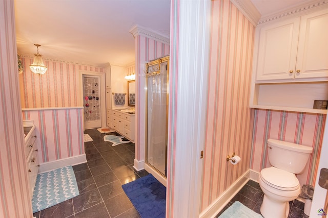 bathroom with toilet, a shower stall, vanity, baseboards, and wallpapered walls