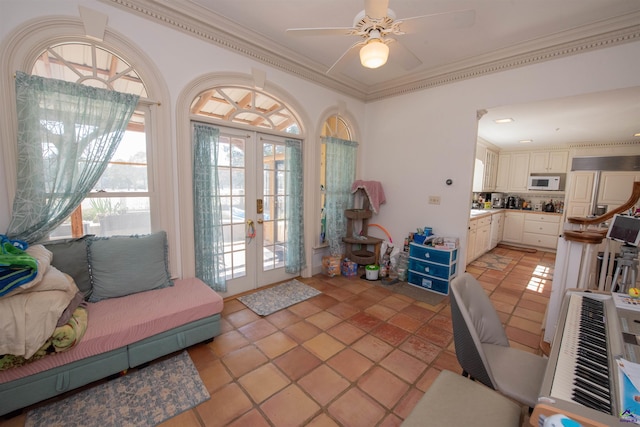 interior space with light tile patterned floors, ornamental molding, a ceiling fan, and french doors