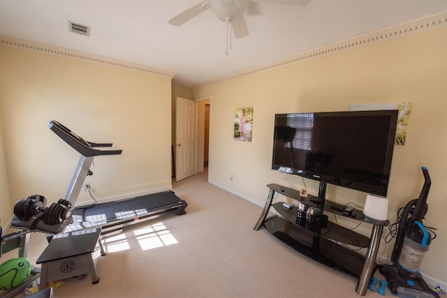 workout area featuring light colored carpet, visible vents, ornamental molding, ceiling fan, and baseboards