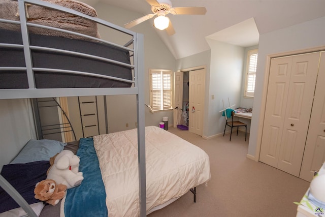 bedroom with light carpet, baseboards, lofted ceiling, ceiling fan, and multiple closets