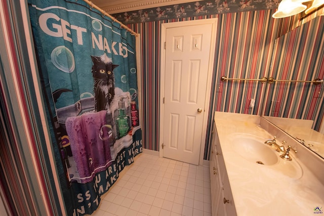 bathroom with baseboards, tile patterned flooring, vanity, and wallpapered walls