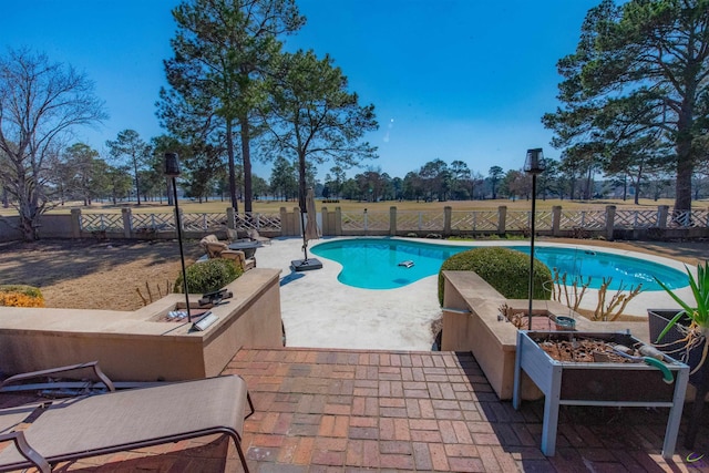 view of swimming pool featuring a patio area, a fenced backyard, a fire pit, and a fenced in pool