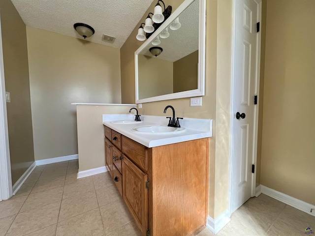 full bathroom with visible vents, a sink, a textured ceiling, and double vanity