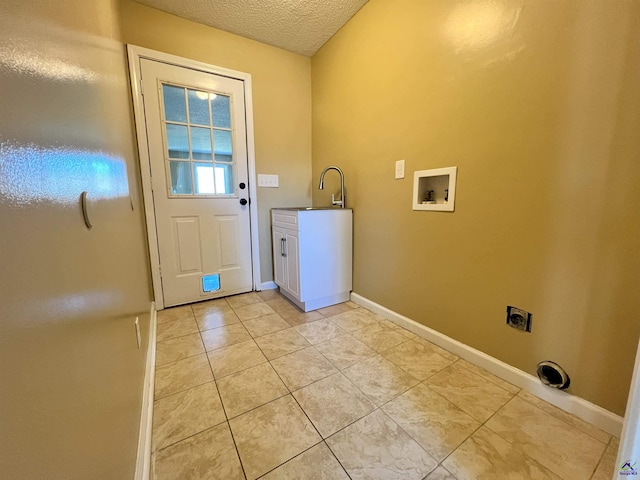 washroom featuring light tile patterned floors, baseboards, electric dryer hookup, a textured ceiling, and a sink