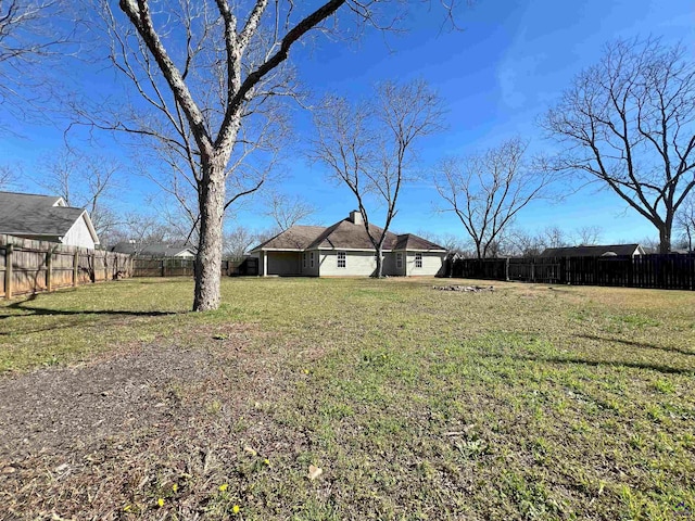 view of yard with a fenced backyard