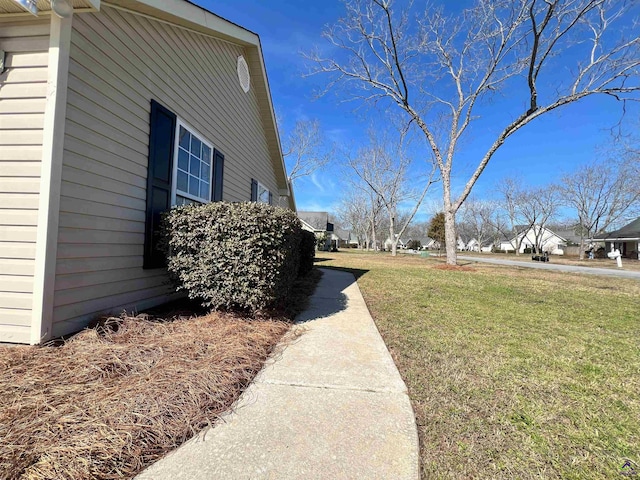 view of property exterior with a yard