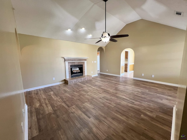 unfurnished living room featuring dark wood-style floors, arched walkways, visible vents, and a ceiling fan