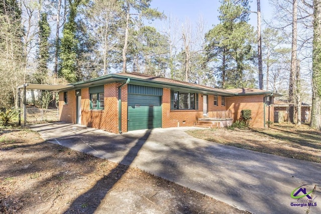 single story home featuring concrete driveway, brick siding, and an attached garage