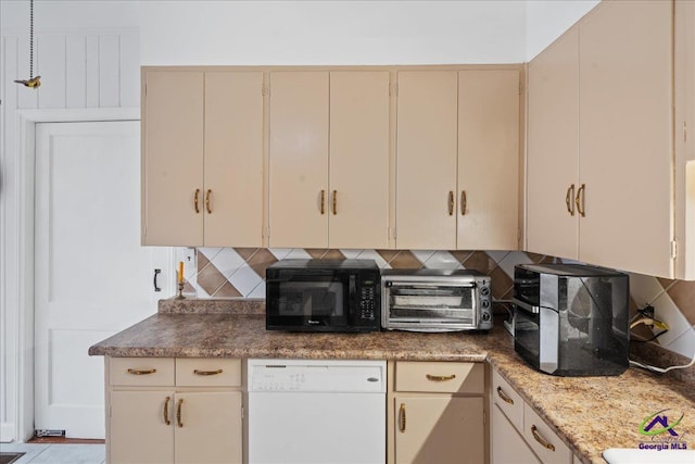 kitchen featuring dishwasher, cream cabinets, backsplash, and black microwave