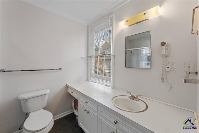 full bath featuring ornamental molding, baseboards, vanity, and toilet