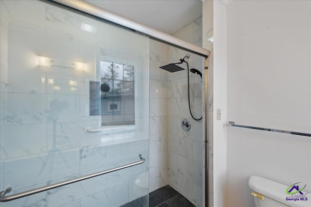 full bath featuring a stall shower and toilet