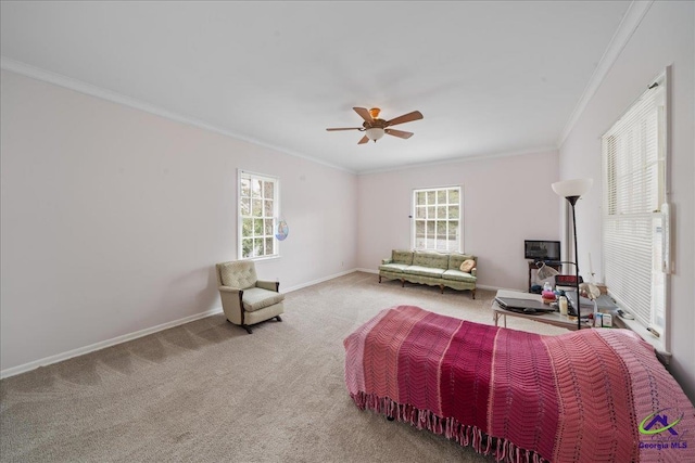 carpeted bedroom featuring a ceiling fan, crown molding, and baseboards