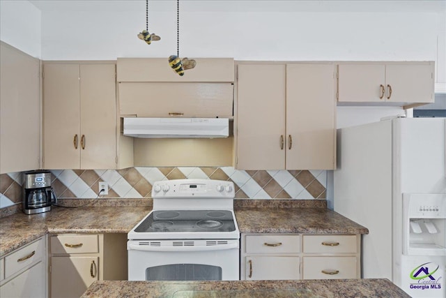 kitchen with white appliances, decorative backsplash, dark countertops, cream cabinets, and under cabinet range hood