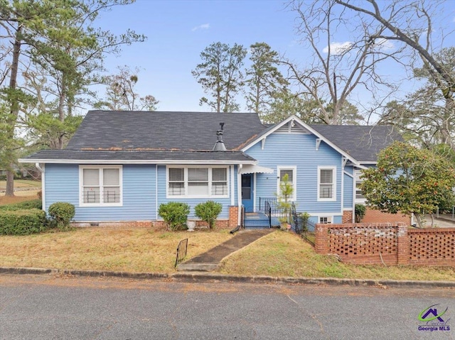 view of front of property with a front lawn and fence