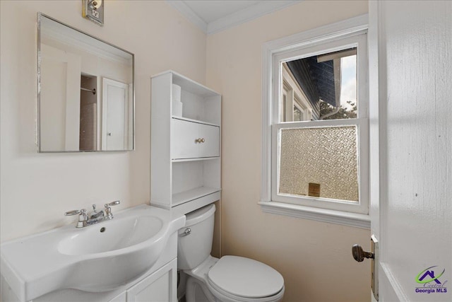 bathroom with toilet, ornamental molding, and vanity