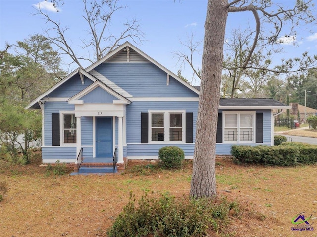 bungalow-style home featuring a front yard