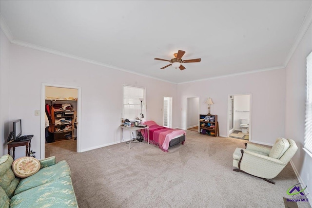 bedroom with carpet floors, ornamental molding, a walk in closet, and baseboards