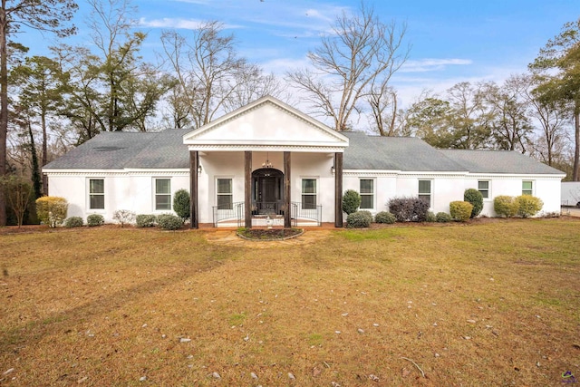 neoclassical home featuring a shingled roof, a porch, a front lawn, and stucco siding