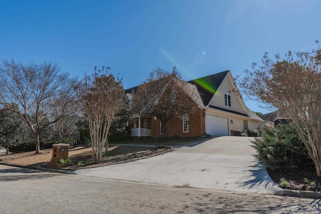 view of front of house featuring driveway and brick siding