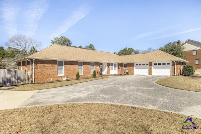 ranch-style home with brick siding, a shingled roof, fence, a garage, and driveway