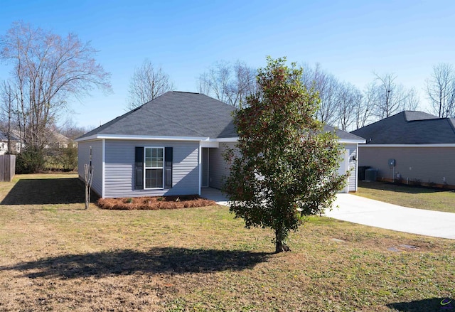 ranch-style house featuring a garage, concrete driveway, and a front yard