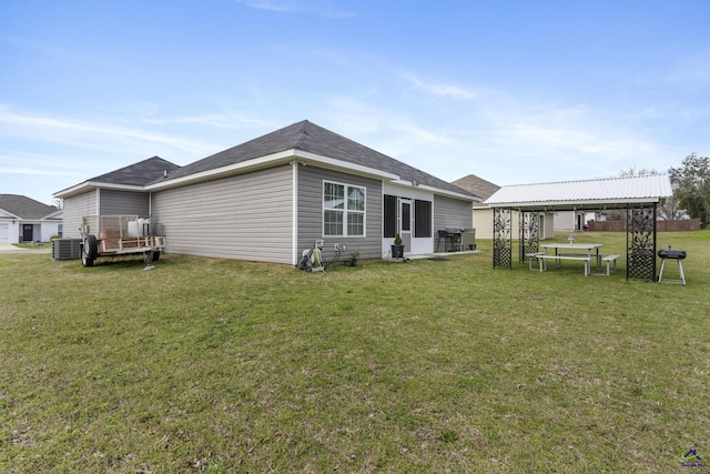 back of property with central air condition unit, a lawn, and a gazebo