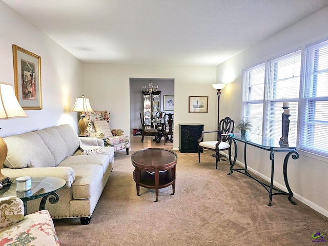 living room with light carpet, baseboards, and an inviting chandelier