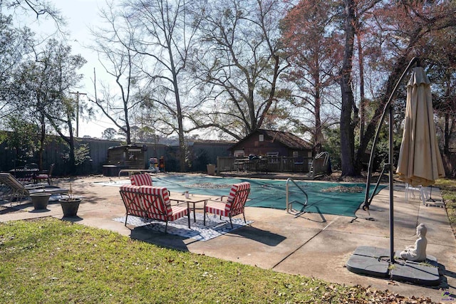 view of pool featuring a patio, fence, and a covered pool