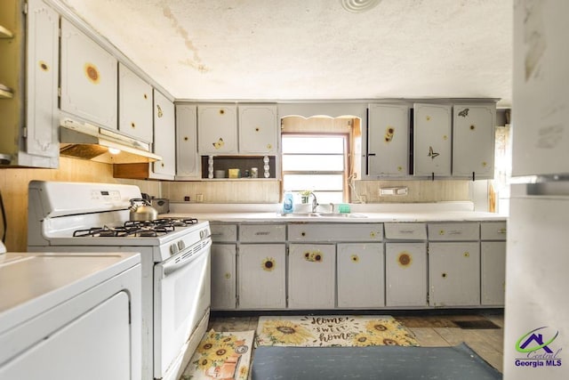 2137 Mutual Ave, Macon, GA 31204 - kitchen featuring gas range gas stove, light countertops, gray cabinetry, a sink, and under cabinet range hood