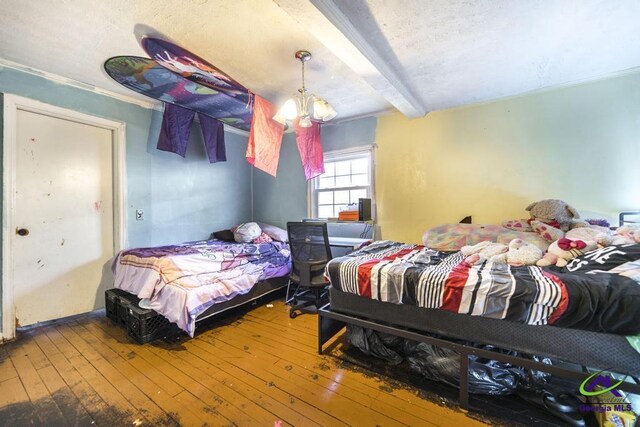 2137 Mutual Ave, Macon, GA 31204 - bedroom with a chandelier, beamed ceiling, and wood finished floors