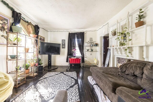 2137 Mutual Ave, Macon, GA 31204 - living room featuring dark wood-type flooring, a textured ceiling, and baseboards