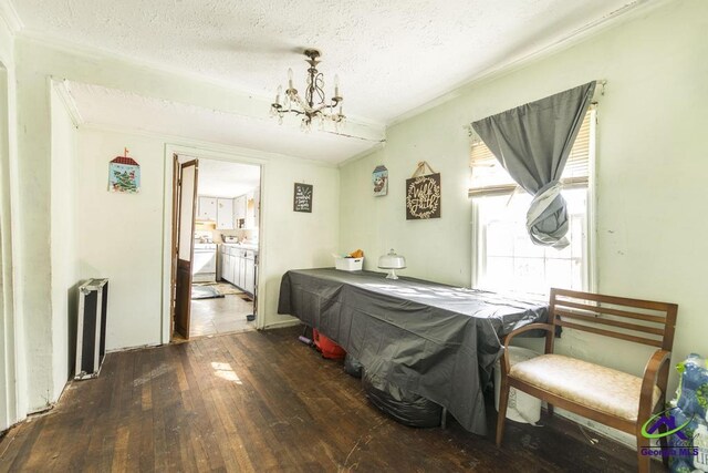 2137 Mutual Ave, Macon, GA 31204 - dining area with a textured ceiling, a notable chandelier, washer and dryer, radiator heating unit, and dark wood finished floors