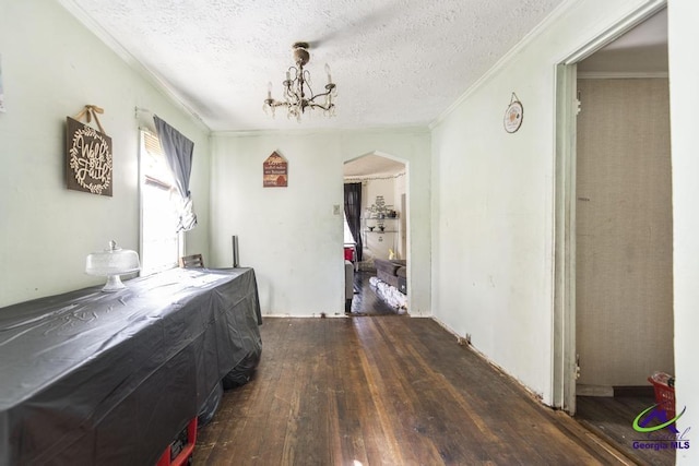 2137 Mutual Ave, Macon, GA 31204 - interior space featuring an inviting chandelier, crown molding, dark wood finished floors, and a textured ceiling