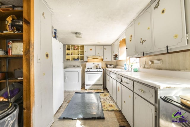 2137 Mutual Ave, Macon, GA 31204 - kitchen featuring white gas range, light countertops, white cabinets, a sink, and washer / dryer