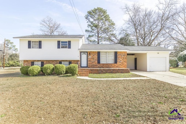 split level home with a garage, concrete driveway, brick siding, and a front yard