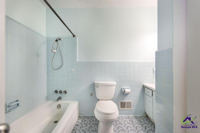 full bathroom with tile walls, visible vents, toilet, wainscoting, and vanity