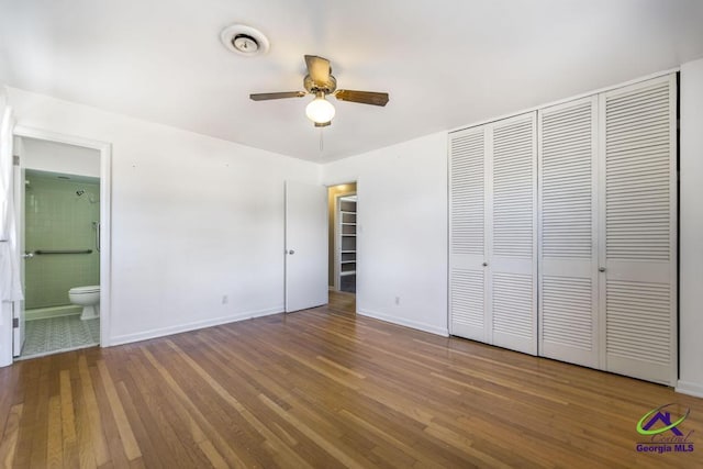 unfurnished bedroom featuring a closet, baseboards, and wood finished floors